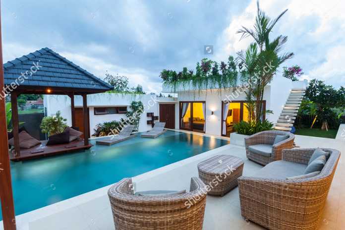 karimun - stock-photo-modern-villa-outdoor-with-swimming-pool-and-gazebo-at-sunset-370294121