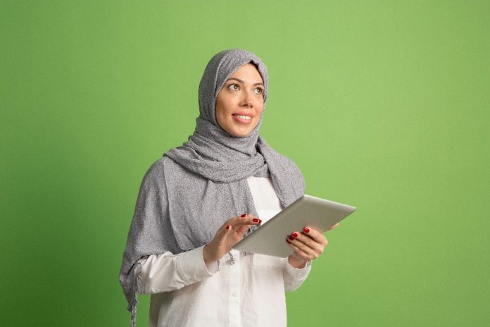 Happy arab woman in hijab. Portrait of smiling girl, posing at studio background